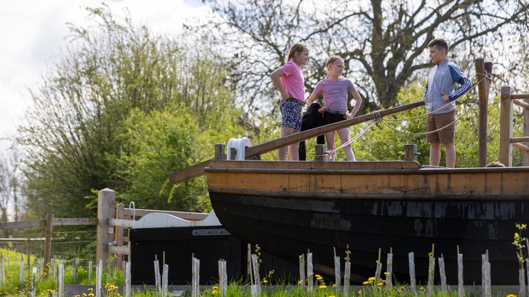 Children on the deck of a trow boat in the new orchard at Brockhampton.